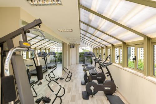 a gym with rows of treadmills and ellipticals at Hotel Dom Carlos Liberty in Lisbon