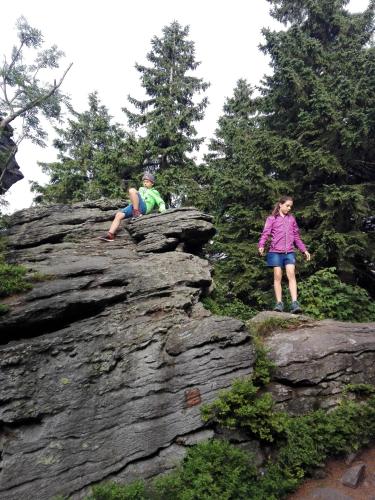 a boy and a girl standing on top of a rock at Penzion La Baita in Branná