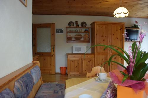 a living room with a table and a couch at Landhaus Unterköfler in Arriach