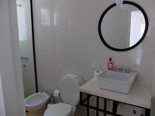 a bathroom with a toilet and a sink and a mirror at CASA MARGARITA 4Piso MonoAmarillo in San Salvador de Jujuy