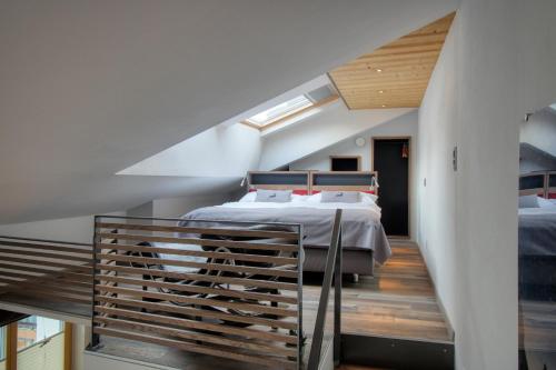 a bedroom with a bed and a staircase at Chalet Abacus in Zermatt