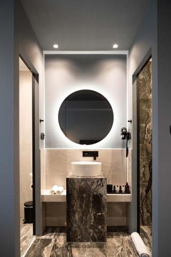 a bathroom with a sink and a mirror at Olympus Terra Boutique Hotel in Larisa