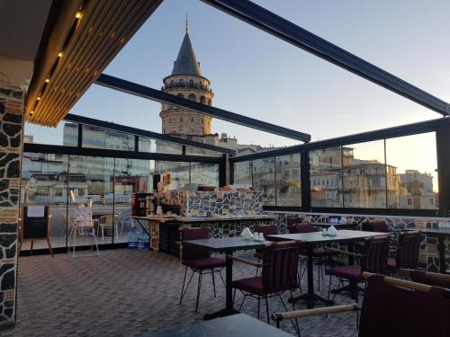 a restaurant with a view of a clock tower at Galatower Hotel in Istanbul