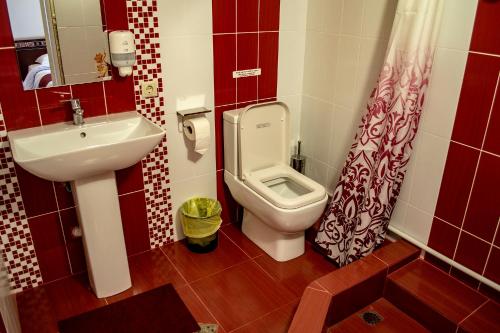 a small bathroom with a toilet and a sink at Stone Art Guest House & Camping in Pemzashen