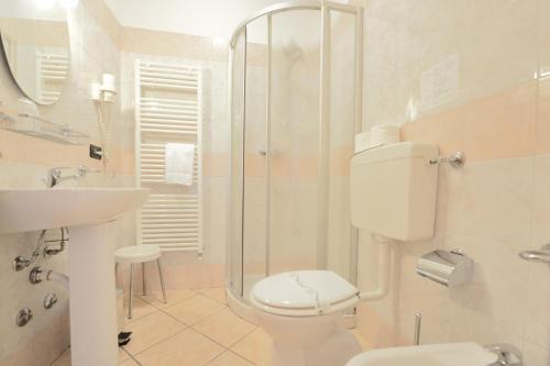 a bathroom with a toilet and a sink and a shower at Albergo Navene in Malcesine