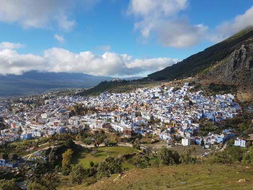 a view of a blue and white city on a hill at Maison d'hôte Bousaid in Chefchaouene