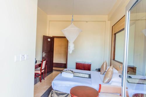 a living room with two beds and a table at Kigaliview Hotel and Apartments in Kigali