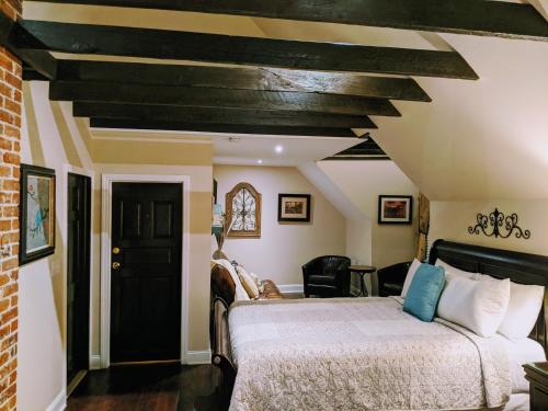 a bedroom with a bed and a black door at Chelsea Pub and Inn in Atlantic City
