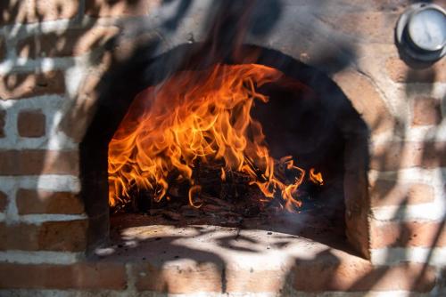 a fire burning in a brick oven at EL PICNIC ATITLÁN in Tzununá