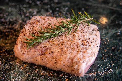 a piece of meat with a sprig of rosemary on top at EL PICNIC ATITLÁN in Tzununá