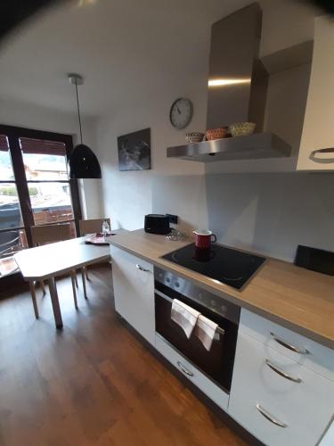 a kitchen with a stove and a counter top at Gästehaus Rappenkopf in Oberstdorf