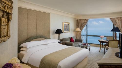 a hotel room with a bed and a large window at InterContinental Phoenicia Beirut by IHG in Beirut