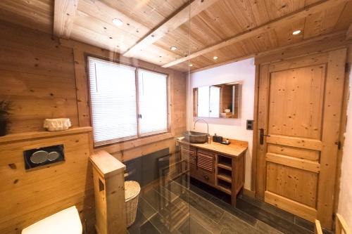 a bathroom with a sink and a toilet in a cabin at Close to the village - Chalet 4 Bedrooms, Mont-Blanc View in Megève