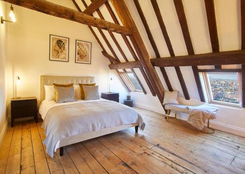 a bedroom with a large bed and two windows at Host & Stay - The Coach House in Whitby
