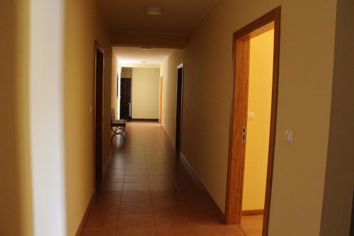 a hallway with two doors and a tile floor at Hotel Minho Belo in Vila Nova de Cerveira