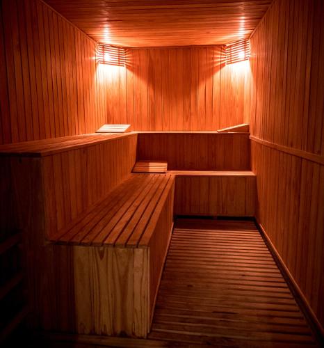 an empty sauna with wooden walls and wooden floors at Gran Bourbon Hotel Asuncion in Asuncion