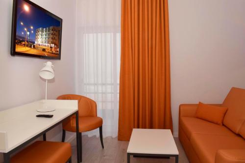 a living room with a couch and a table at THE FOZ Beach Hotel in Figueira da Foz