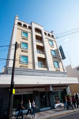 a group of people walking in front of a building at Best Western Centro Monterrey in Monterrey