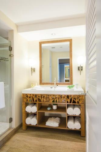 a bathroom with a sink and a mirror and towels at Margaritaville Resort Casino in Bossier City
