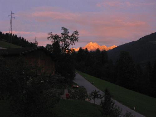 a road with a mountain in the distance at sunset at Haus Panorama in Gerlosberg