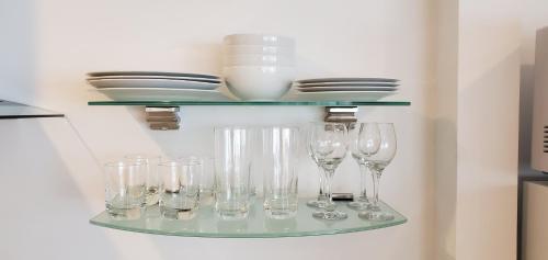 a shelf with wine glasses and plates on it at Sea Horse Resort in San Clemente