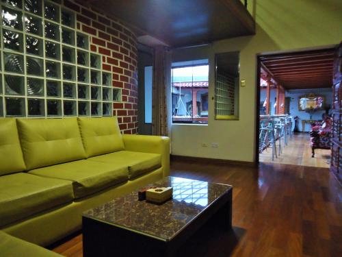 a living room with a couch and a coffee table at Hotel San Francisco Plaza in Cusco