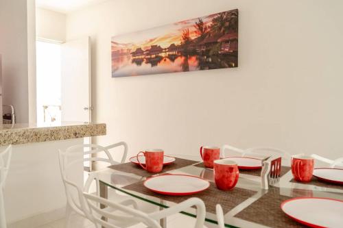 a dining room with a table and white chairs at Luxury Condo, the hidden gem Playa Chacá. Live it! in Progreso