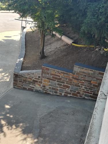 a brick retaining wall with a tree in it at Järgen Ferienappartements in Koblenz