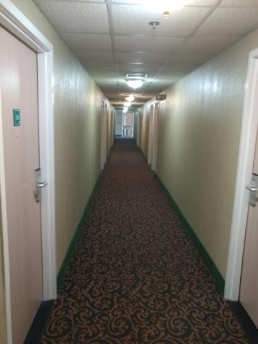a hallway in an office building with a long corridor at Super 8 by Wyndham New Cumberland in New Cumberland
