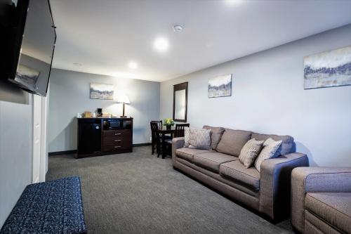 a living room with a couch and a table at Mt. Madison Inn & Suites in Gorham