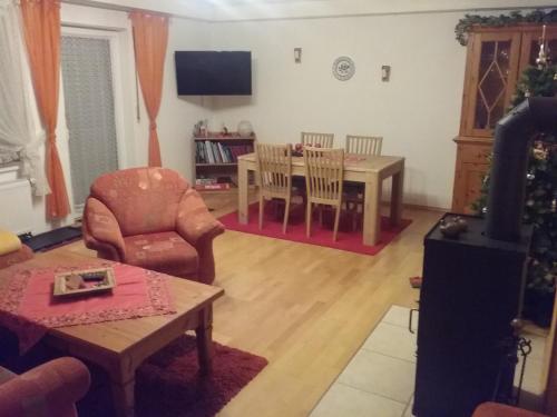 a living room with a table and a chair at Schöne Aussicht in Vöhl