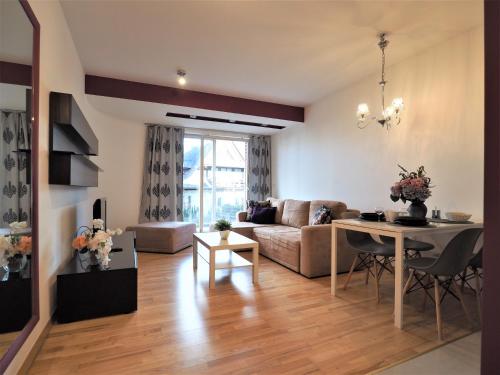 a living room with a couch and a table at VIP Apartamenty Stara Polana 2 in Zakopane