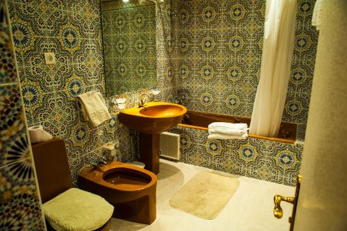 uma casa de banho com um lavatório, um WC e um chuveiro em Hotel Saghro em Tinghir