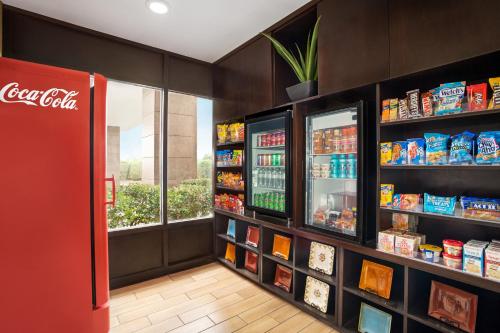 a cocacola store with a cocacola refrigerator at La Quinta Inn & Suites by Wyndham Richmond-Midlothian in Midlothian