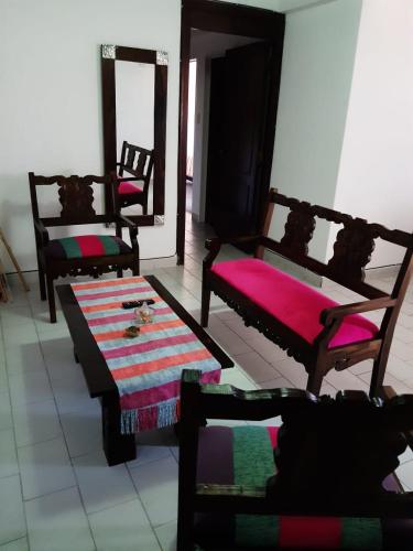 ein Wohnzimmer mit Stühlen und einem Tisch mit einem Teppich in der Unterkunft Departamento Plaza in San Salvador de Jujuy