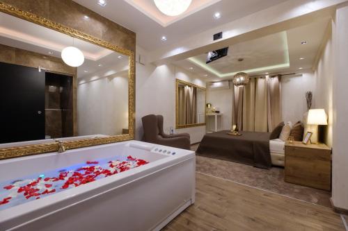 a bathroom with a tub filled with red flowers at Central Business Apartments Jacuzzi in Belgrade