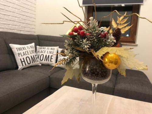 a vase with a christmas arrangement on a table at Apartament Centrum Zakopane in Zakopane