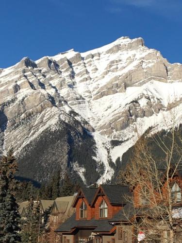 a house in front of a snow covered mountain at Hillside Bungalows in Banff