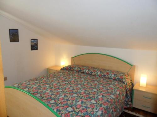 a bedroom with a bed and two night stands at MANSARDA PARADISO GOLFO DI PORTOFINO in Sestri Levante