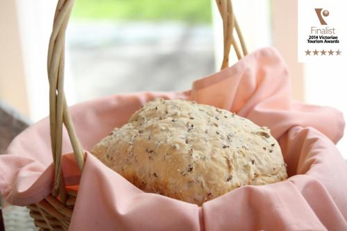 a bread in a pink basket with two forks at Lakeside Cottage Luxury B&B in Mount Dandenong
