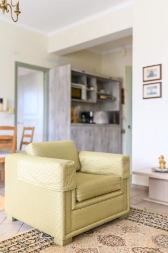 a living room with a chair and a table at 3BD Apartment in the Center - Self check in in Patra