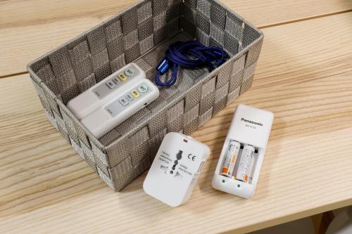 a box of remote controls sitting on a table at Spacious & Modern Inn Megumi-an Nishijin in Kyoto