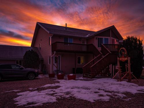 a house with a car parked in front of it at Bryce Trails Bed and Breakfast in Tropic