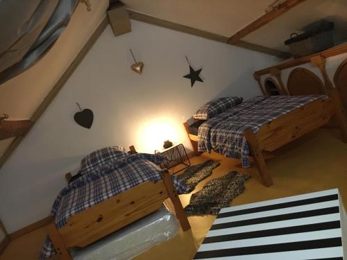 an overhead view of a bedroom with two beds and an attic at La Pénates in Château-Regnault-Bogny