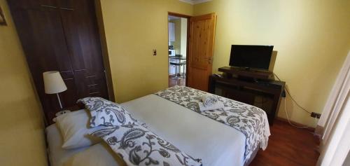 Una cama o camas en una habitación de Apart Hotel Uman