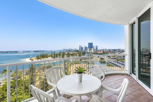 a balcony with a table and chairs and a view of the ocean at Crystal Bay On The Broadwater in Gold Coast