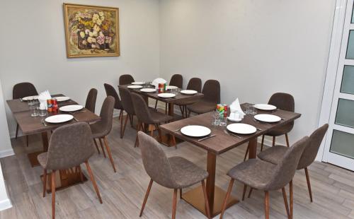 a dining room with wooden tables and chairs at Bonjour Boutique Hotel Yerevan in Yerevan