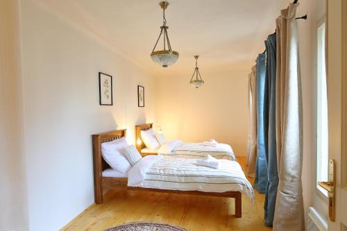 a bedroom with two beds and a window at Lucerna - dům s duší Příbor in Příbor