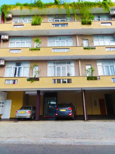 two cars parked in front of a building at VIVAS Residencies Luxury Apartments in Colombo