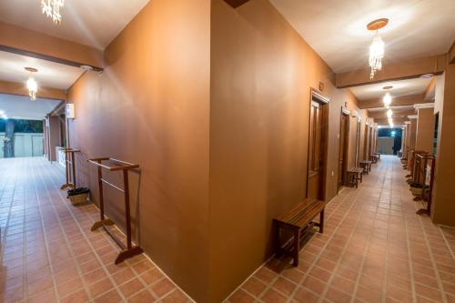 a corridor with a row of benches in a building at Traveller Lodge Ngapali by River Top in Ngapali